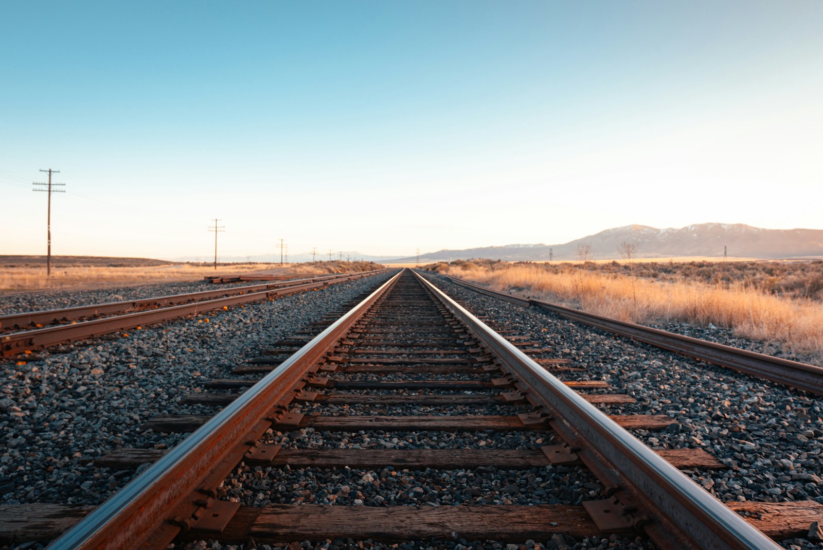 Railroad track extending across an open landscape